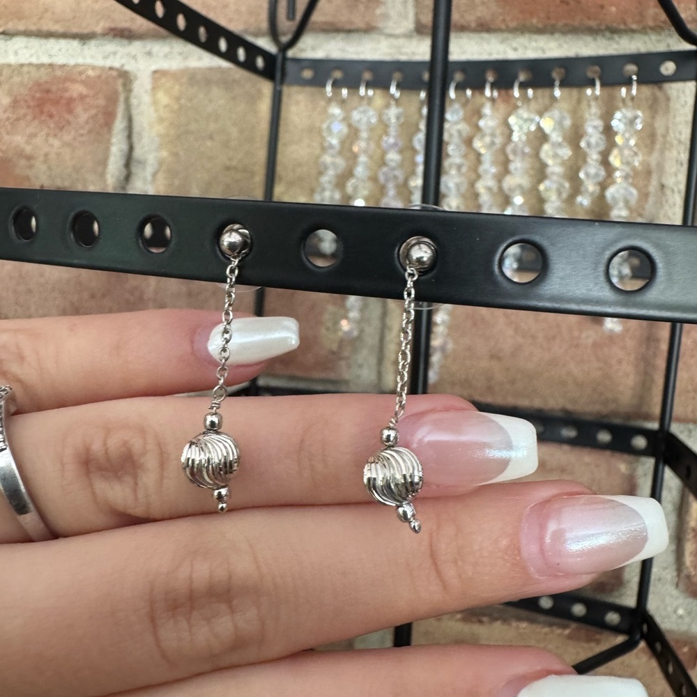 Platinum ball dangle earrings.